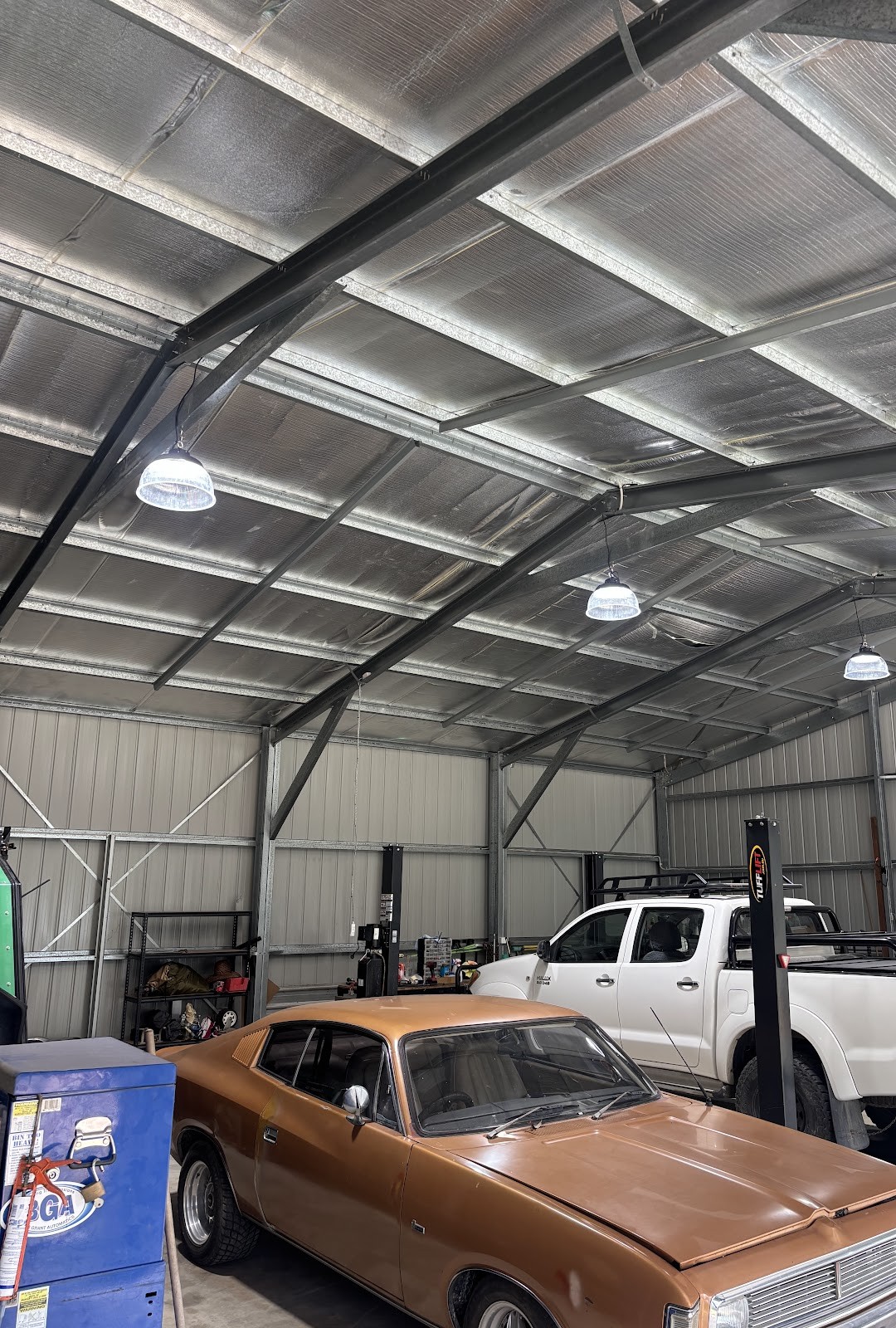 Large steel shed lit by high-bay pendant lights